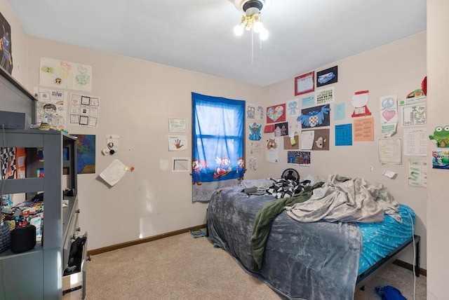 carpeted bedroom featuring baseboards and ceiling fan