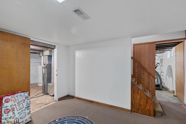 interior space featuring stairway, carpet flooring, baseboards, and visible vents