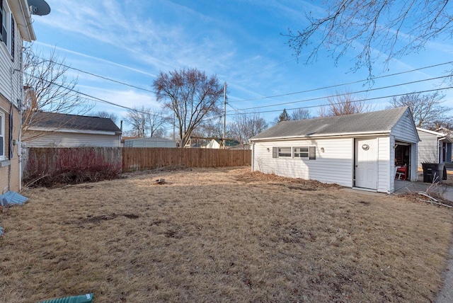 view of yard with an outdoor structure and fence