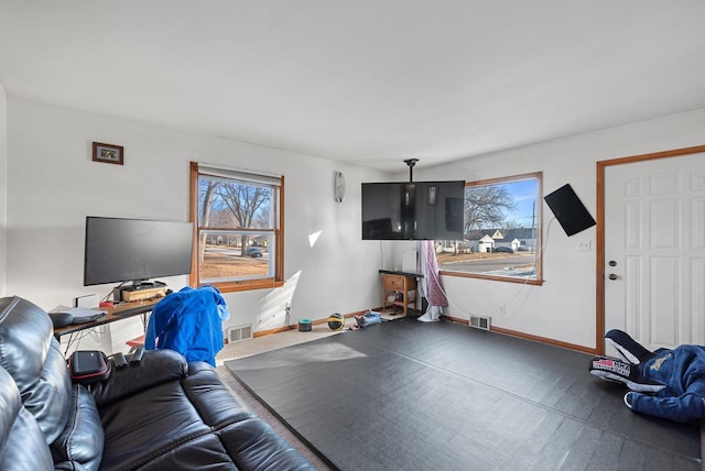 living room with visible vents and baseboards