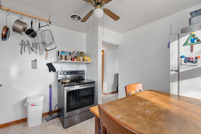 kitchen with visible vents, stainless steel electric stove, freestanding refrigerator, baseboards, and ceiling fan