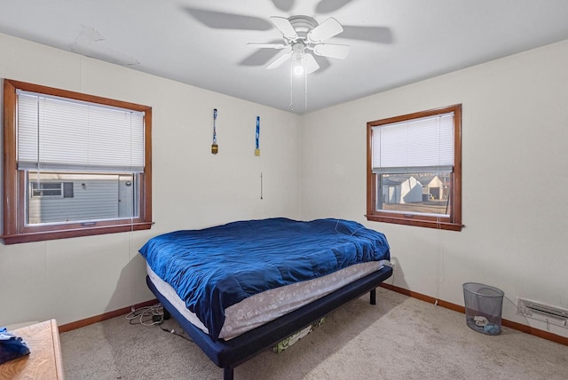 carpeted bedroom with a ceiling fan and baseboards