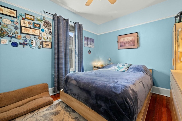 bedroom with baseboards, wood finished floors, and a ceiling fan