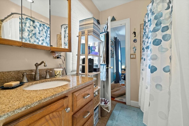 bathroom featuring vanity and a shower with shower curtain