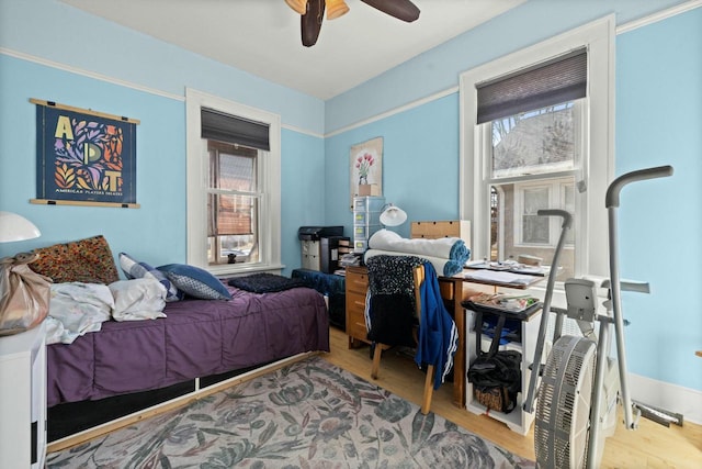 bedroom with ceiling fan and wood finished floors