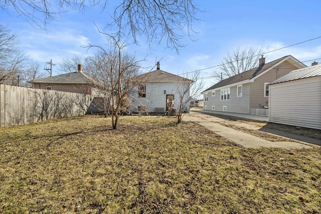 back of property featuring fence