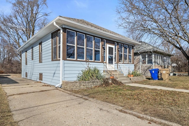 view of front facade featuring driveway and a sunroom