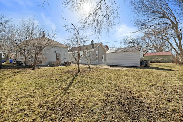 exterior space with an outbuilding and a lawn