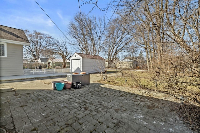 view of patio / terrace with an outbuilding, a storage shed, and fence