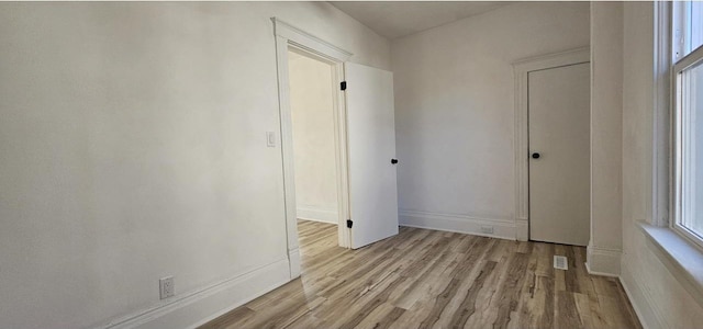 interior space with wood finished floors and baseboards