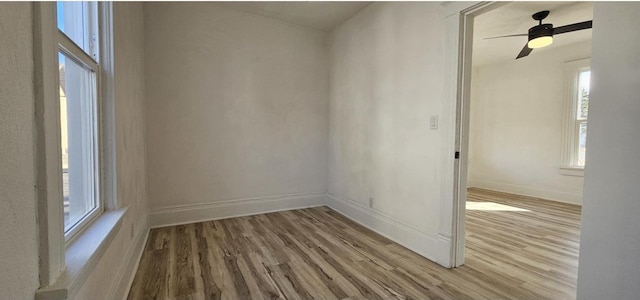 empty room featuring baseboards and wood finished floors