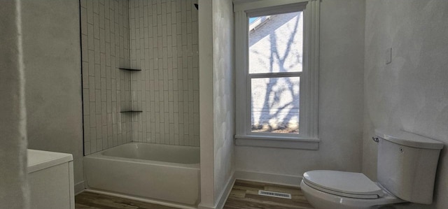 full bathroom featuring a wealth of natural light, visible vents, toilet, and wood finished floors