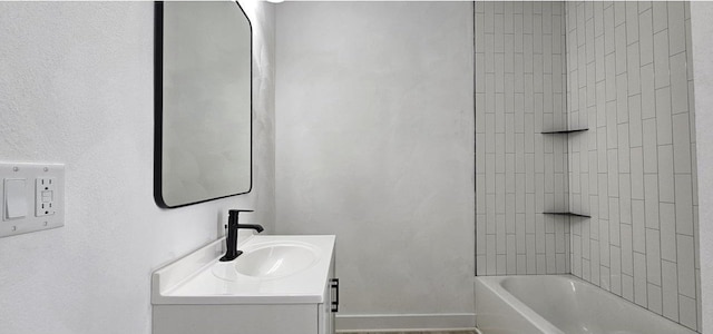 bathroom featuring shower / washtub combination, vanity, and baseboards