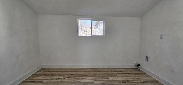 interior space featuring baseboards and wood finished floors