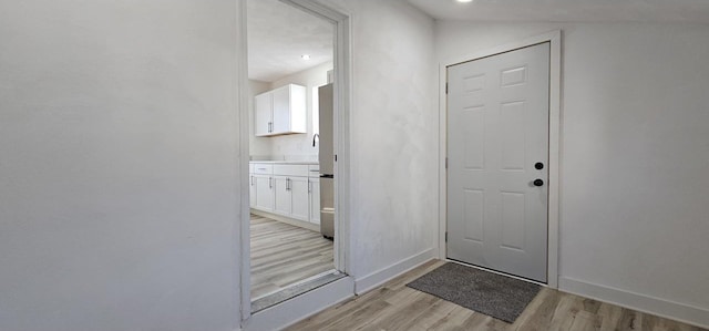 entryway featuring light wood-type flooring and baseboards