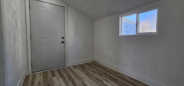 additional living space with lofted ceiling, baseboards, and wood finished floors