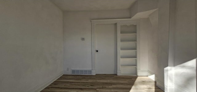 interior space featuring wood finished floors and visible vents