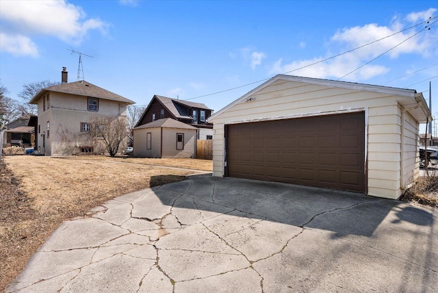 exterior space with a detached garage and an outdoor structure