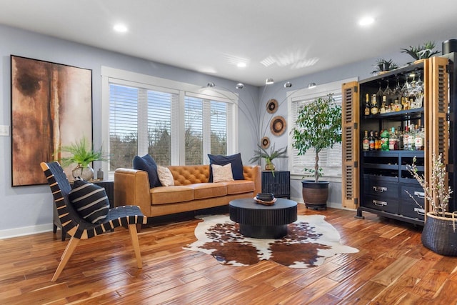 living room with recessed lighting, baseboards, and wood finished floors