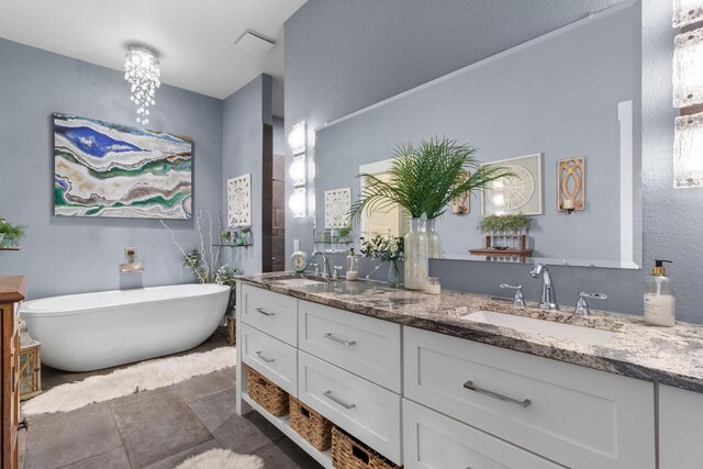 bathroom with double vanity, a soaking tub, and a sink