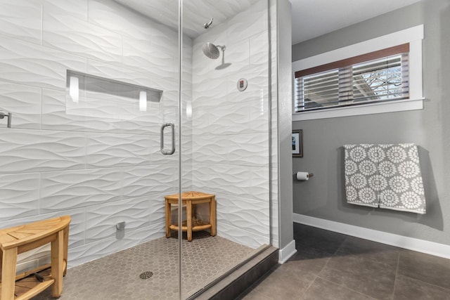 full bath with baseboards, a stall shower, and tile patterned flooring