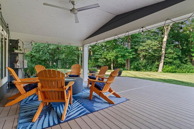 wooden terrace with a yard and a ceiling fan