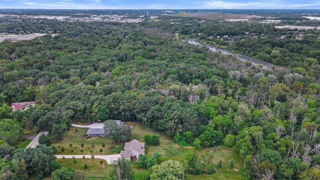 aerial view featuring a wooded view and a water view