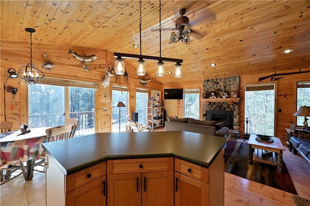 kitchen featuring wooden ceiling, dark countertops, wood walls, and lofted ceiling