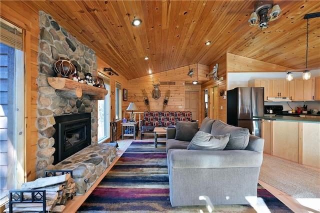 living room with wood walls, a fireplace, wood ceiling, and vaulted ceiling