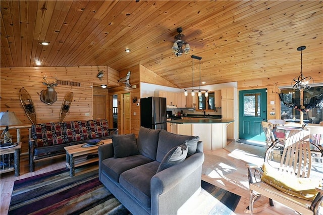 living room with wood walls, light wood-type flooring, wooden ceiling, an inviting chandelier, and high vaulted ceiling