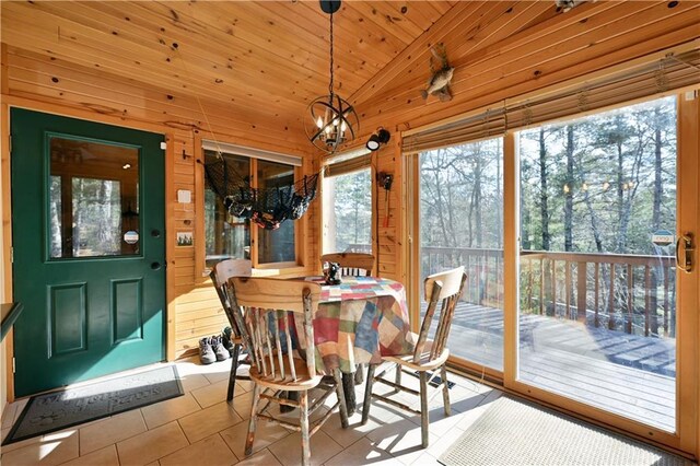 sunroom with wood ceiling, an inviting chandelier, and vaulted ceiling