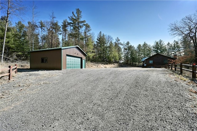 detached garage featuring fence