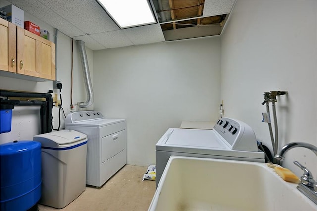 laundry area featuring cabinet space, washing machine and dryer, and a sink