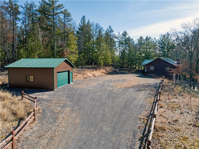 view of road featuring driveway and a forest view