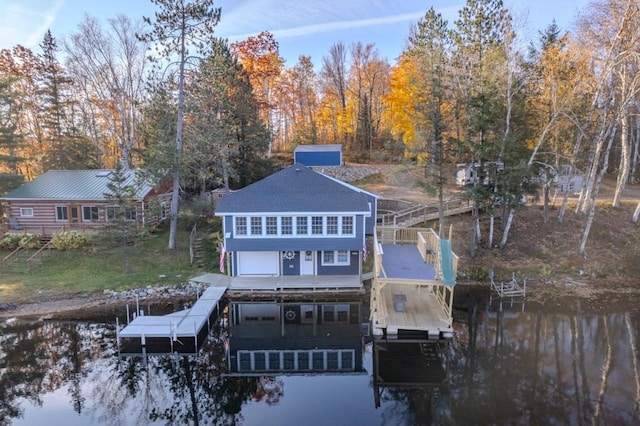 rear view of house with boat lift and stairs