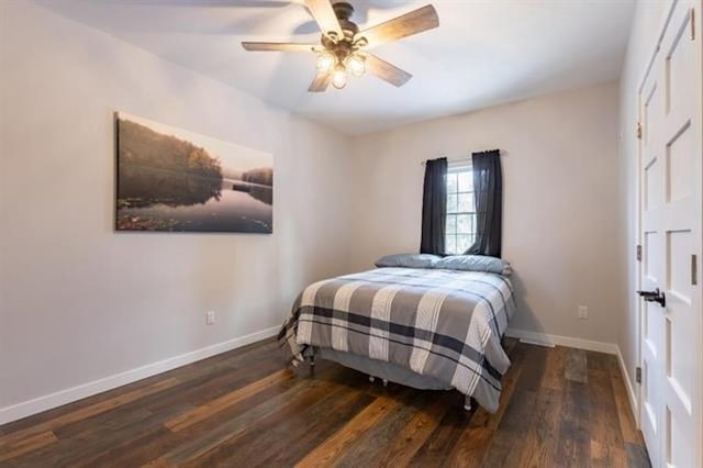 bedroom featuring ceiling fan, baseboards, and wood finished floors