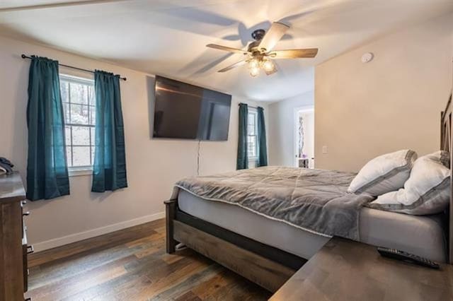 bedroom with ceiling fan, baseboards, lofted ceiling, and wood finished floors