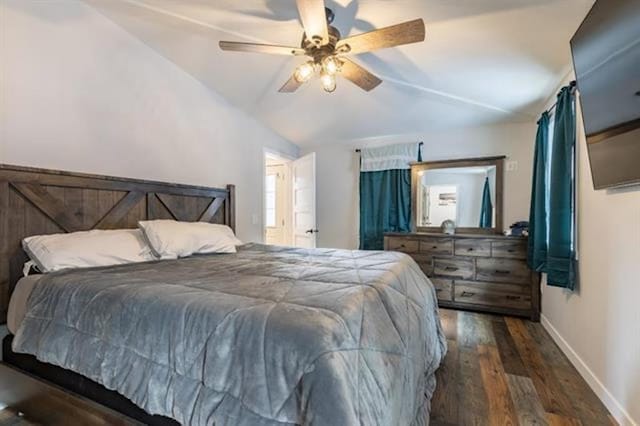 bedroom featuring dark wood finished floors, lofted ceiling, a ceiling fan, and baseboards