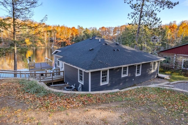 rear view of house with a shingled roof