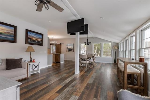 living area with baseboards, lofted ceiling, dark wood-style floors, and ceiling fan with notable chandelier