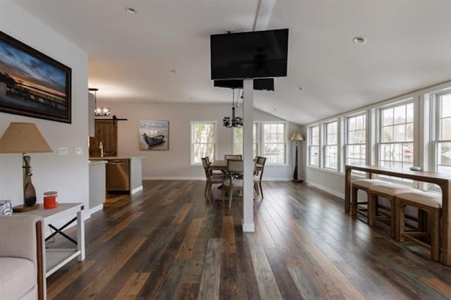 dining space featuring vaulted ceiling, a notable chandelier, baseboards, and dark wood-style flooring