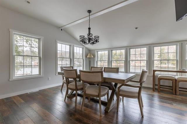 dining room with an inviting chandelier, lofted ceiling, dark wood finished floors, and baseboards