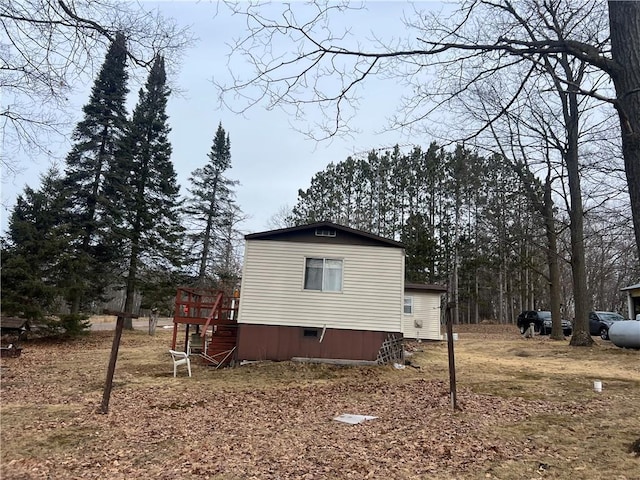 view of side of home featuring stairway