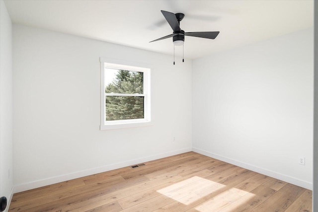 spare room featuring light wood-style flooring, baseboards, visible vents, and ceiling fan