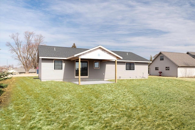 rear view of property with a yard and a patio area