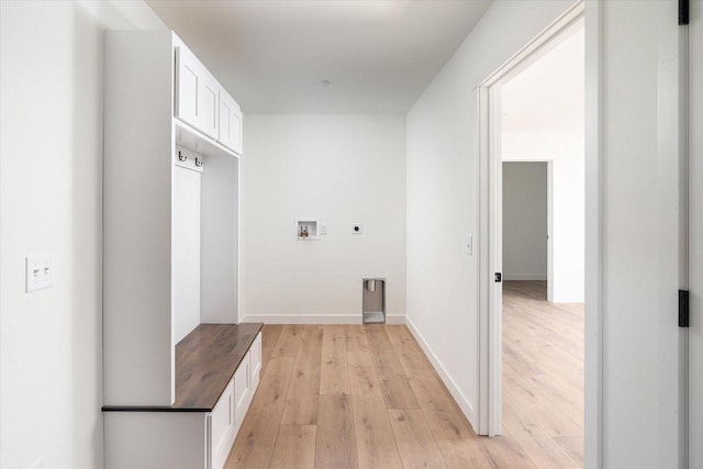 laundry room with washer hookup, cabinet space, light wood finished floors, baseboards, and hookup for an electric dryer