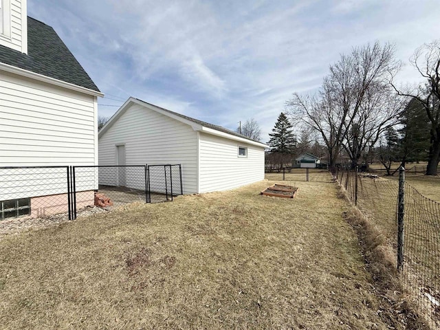 view of yard with a garage and a fenced backyard