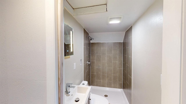 full bath with a textured wall and a stall shower