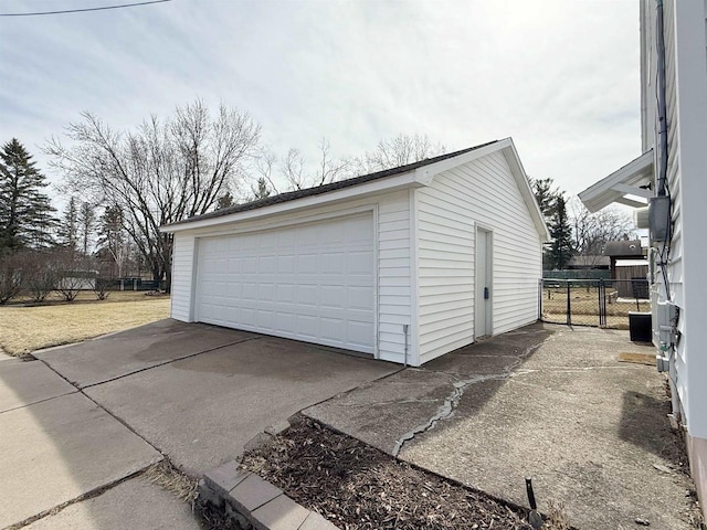 detached garage featuring fence