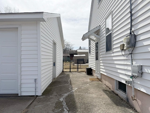 view of property exterior with fence and a garage